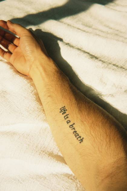 Citation « Life is a breath » sur le bras